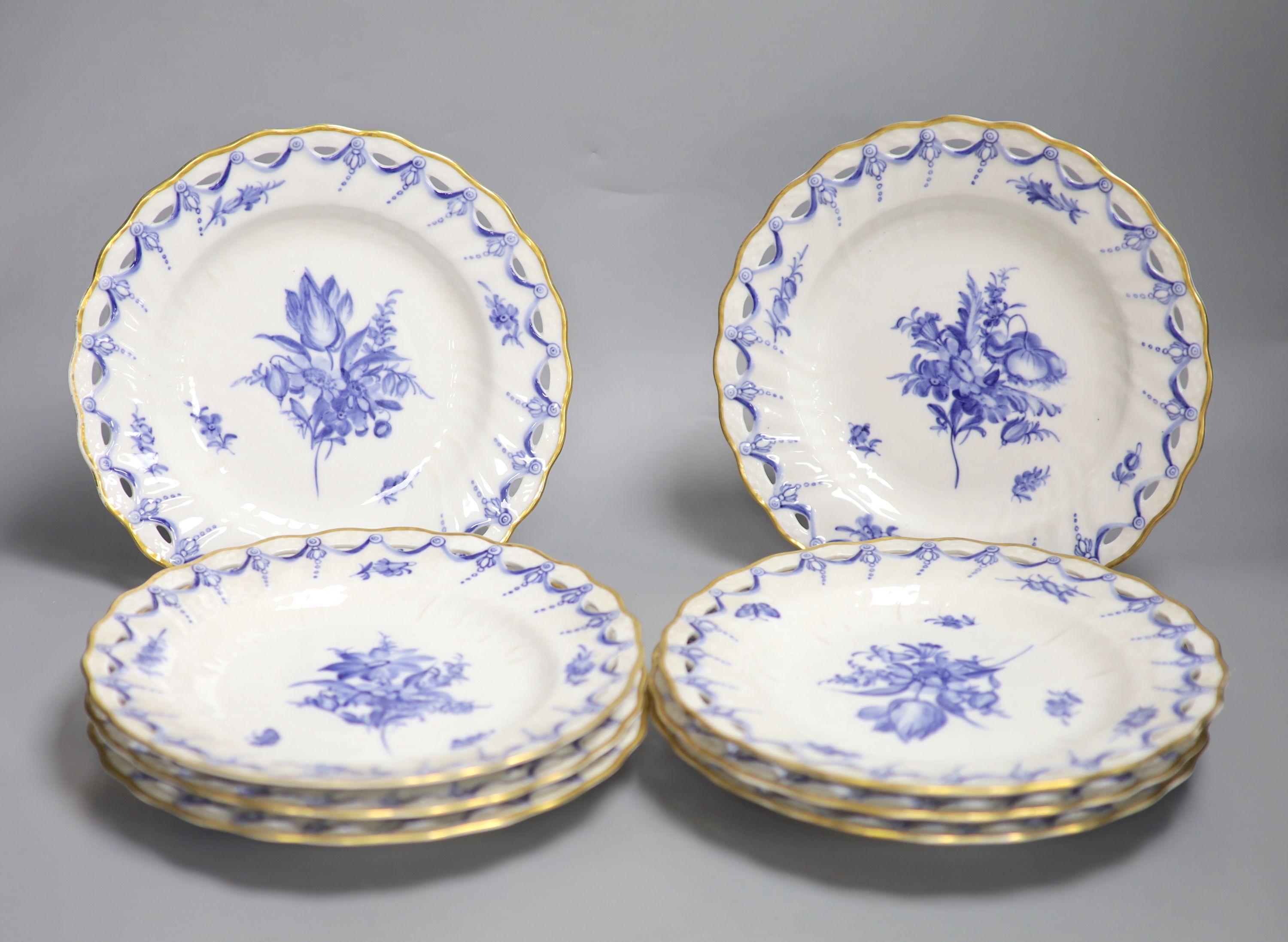 A set of eight Copenhagen plates, painted with flowers in underglaze blue surrounded by a pierced border, 1870-90, diameter 23cm